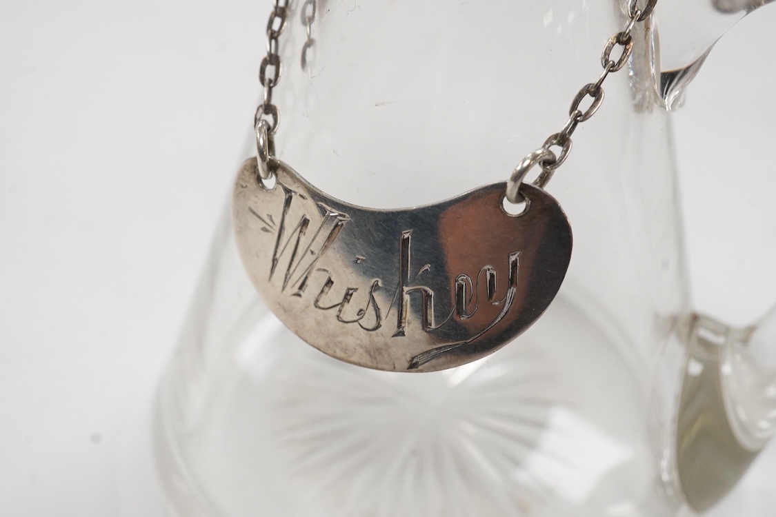 An Edwardian silver mounted glass whisky noggin and matching silver 'Whisky' label by Goldsmiths & Silversmiths Co Ltd, London, 1907, height 10.8cm.